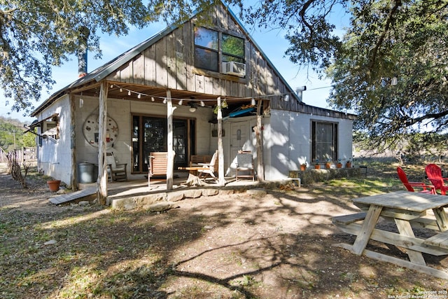 back of house featuring a patio area and concrete block siding