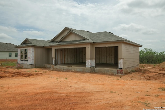 rear view of property with an attached garage