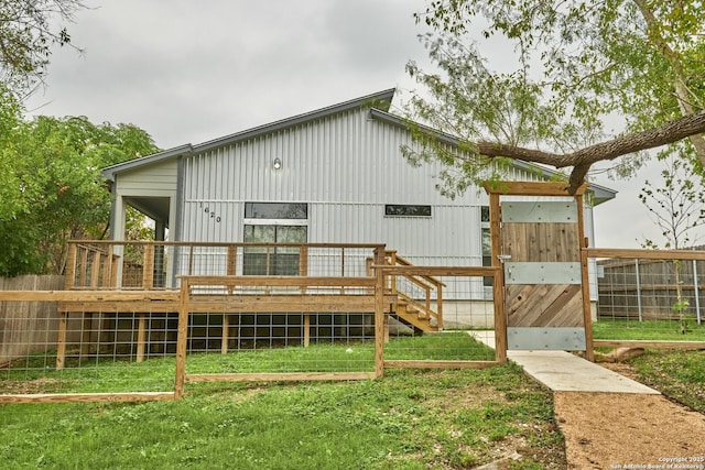 1620 Peck Ave, San Antonio, TX 78218 - rear view of house featuring fence, a wooden deck, and a lawn
