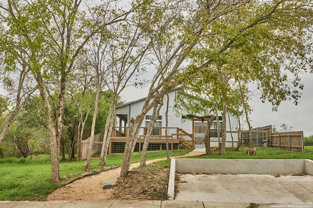 exterior space with a yard, a wooden deck, and fence