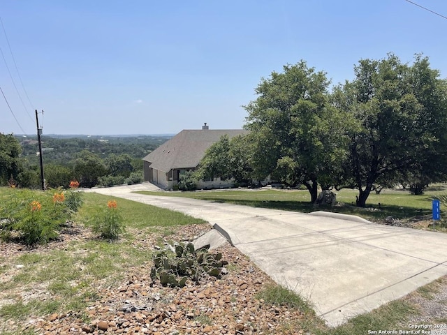 view of street with concrete driveway
