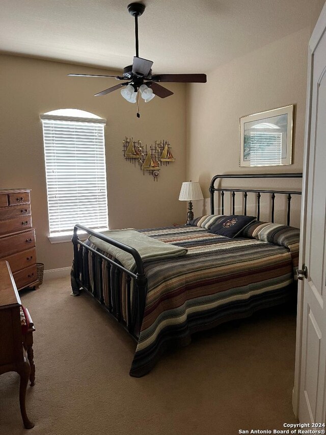 carpeted bedroom featuring ceiling fan