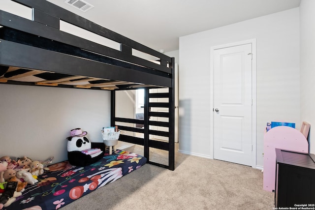 carpeted bedroom featuring visible vents