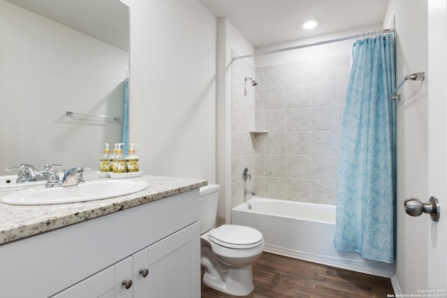 full bathroom with toilet, vanity, wood finished floors, and shower / tub combo with curtain