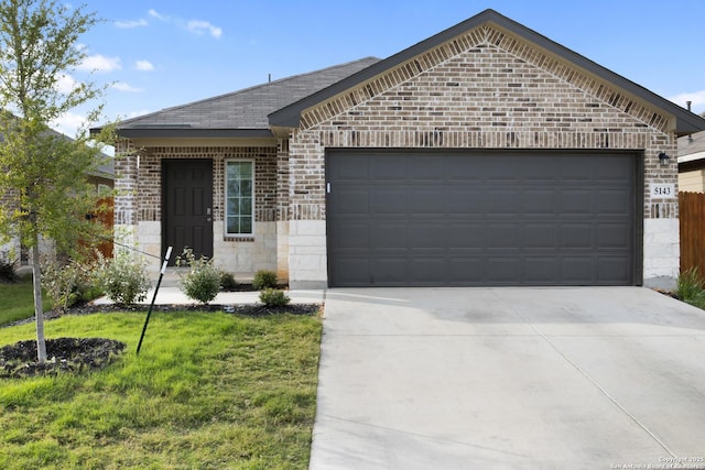 view of front of property featuring a garage, brick siding, a shingled roof, driveway, and stone siding