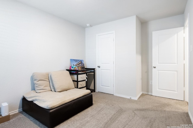 sitting room featuring carpet and baseboards