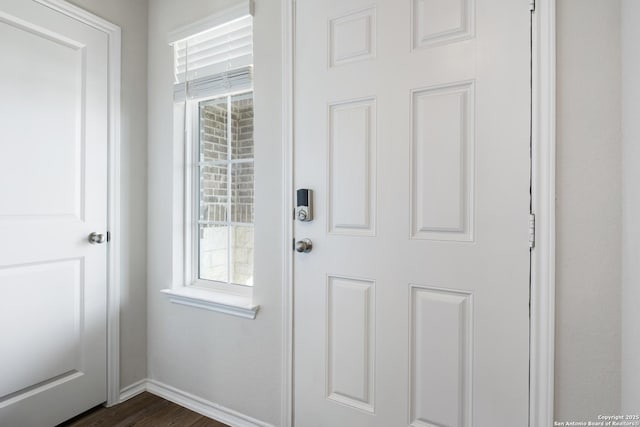 entryway featuring dark wood-style floors and baseboards