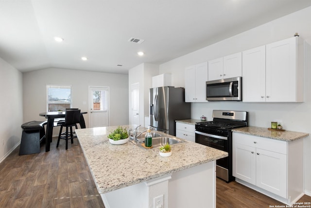 kitchen with white cabinets, visible vents, stainless steel appliances, and a sink