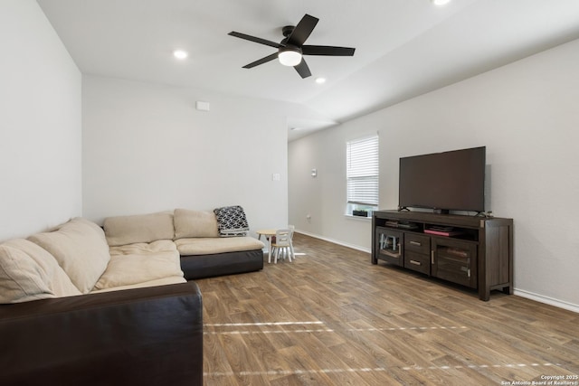 living room featuring baseboards, wood finished floors, and recessed lighting