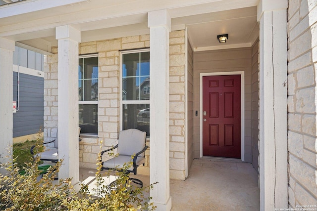 property entrance with stone siding and covered porch