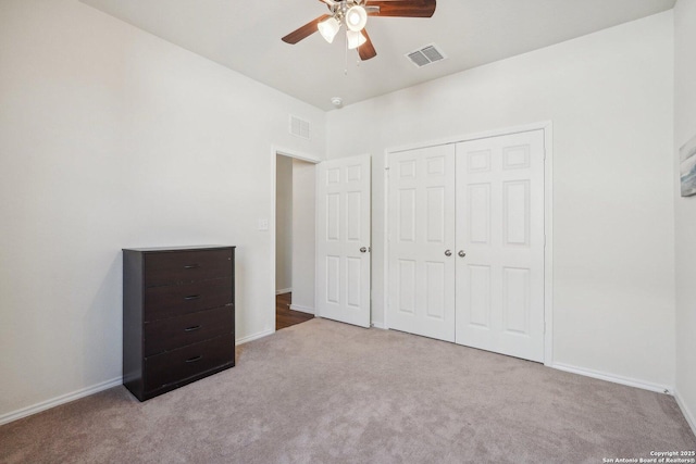 unfurnished bedroom with carpet floors, visible vents, and baseboards