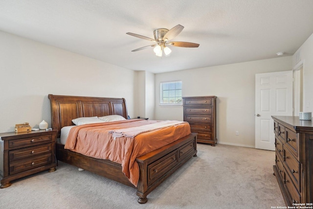 bedroom featuring light carpet, a ceiling fan, and baseboards