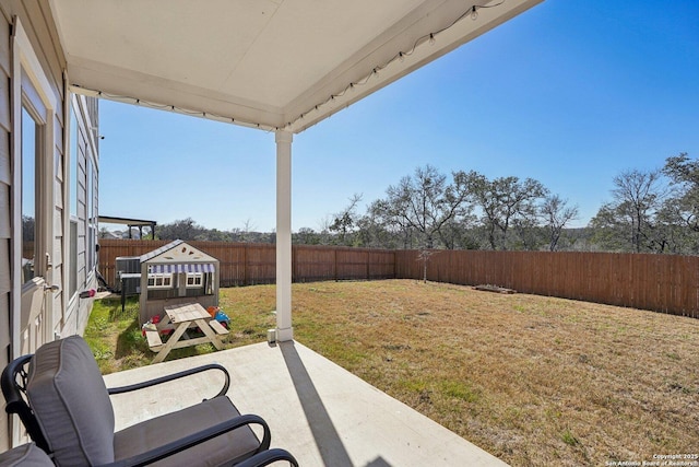 view of yard featuring a patio area and a fenced backyard