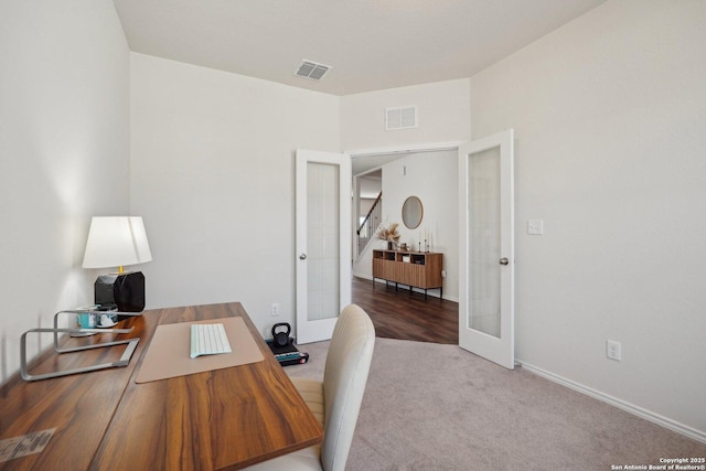 carpeted office with french doors, visible vents, and baseboards