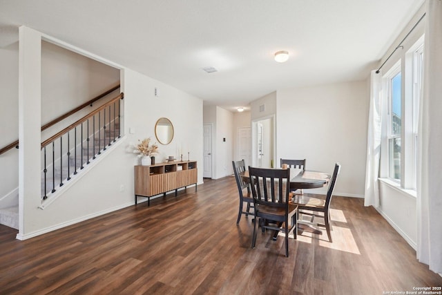 dining area featuring stairs, baseboards, and dark wood-type flooring