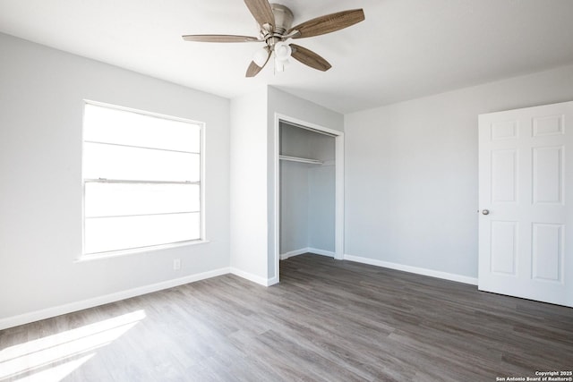 unfurnished bedroom with a closet, ceiling fan, baseboards, and wood finished floors