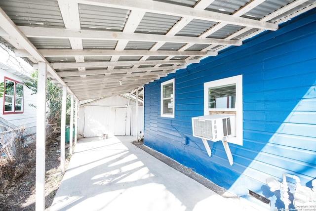 view of patio with an outbuilding, a storage unit, and cooling unit