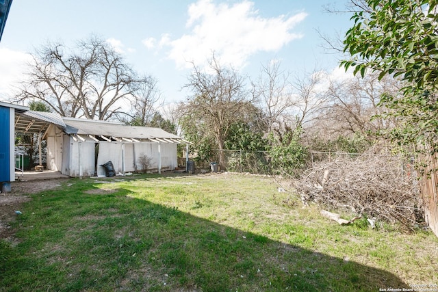 view of yard with an outbuilding and fence