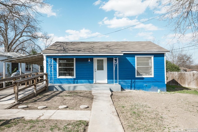 bungalow featuring covered porch and fence