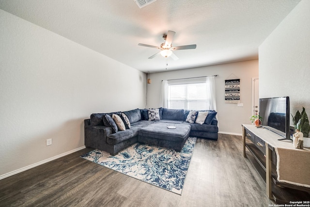 living room with visible vents, ceiling fan, a textured ceiling, wood finished floors, and baseboards