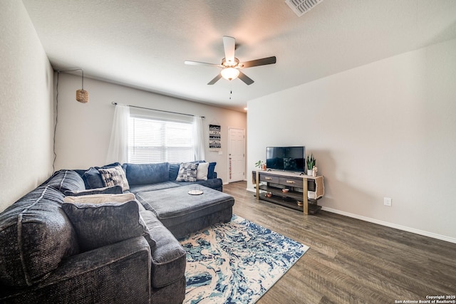 living room with visible vents, ceiling fan, a textured ceiling, wood finished floors, and baseboards