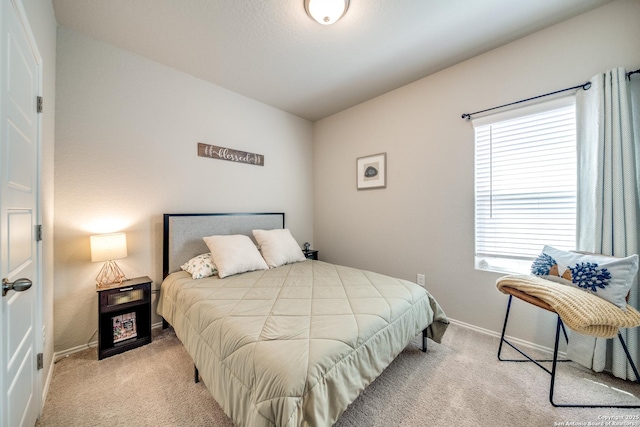 carpeted bedroom featuring lofted ceiling and baseboards