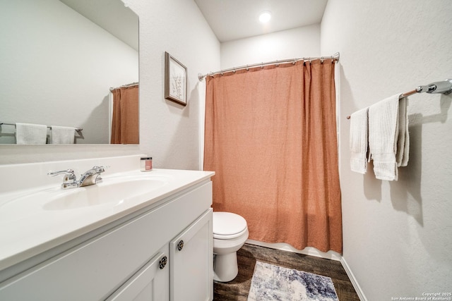 full bathroom with toilet, a shower with curtain, wood finished floors, and vanity