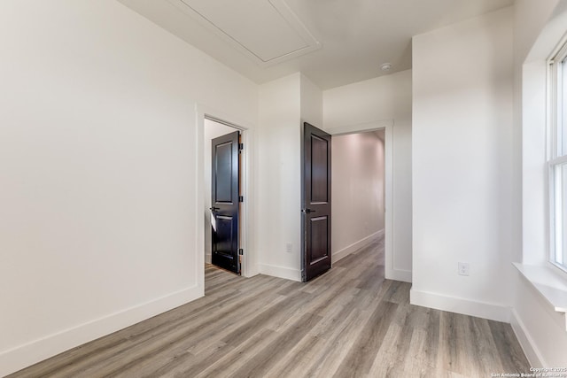 unfurnished room featuring light wood-type flooring and baseboards