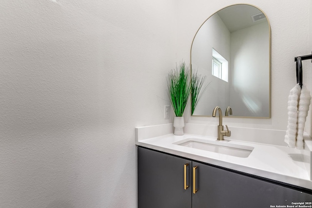 bathroom with visible vents and vanity