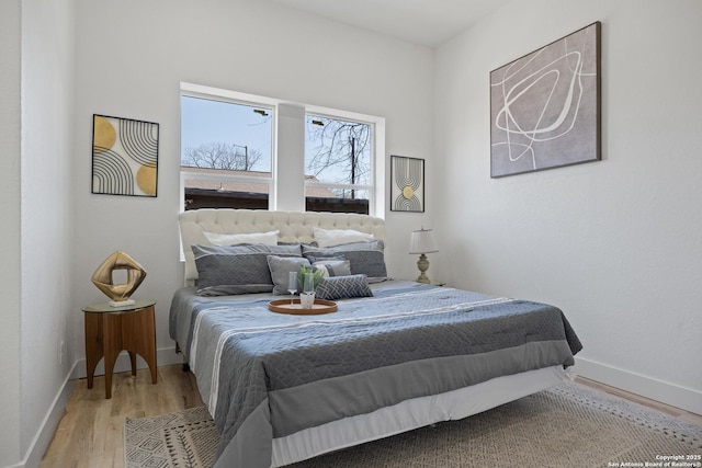 bedroom with light wood-type flooring and baseboards