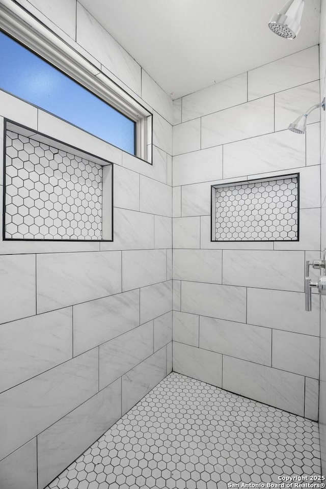 full bathroom with tiled shower