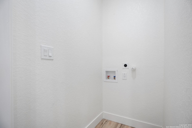 laundry area with washer hookup, light wood-style floors, electric dryer hookup, laundry area, and baseboards