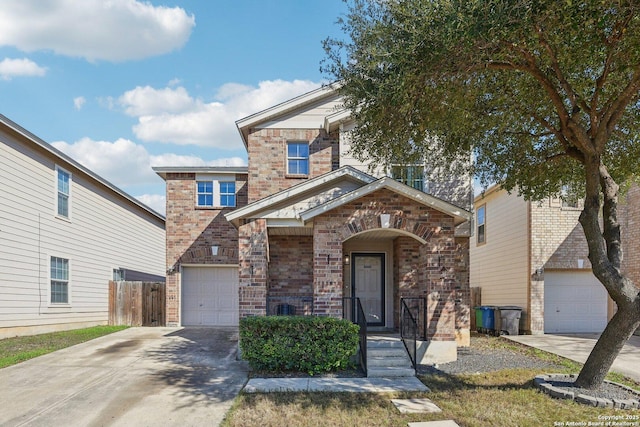 view of front of property with driveway, a garage, fence, and brick siding