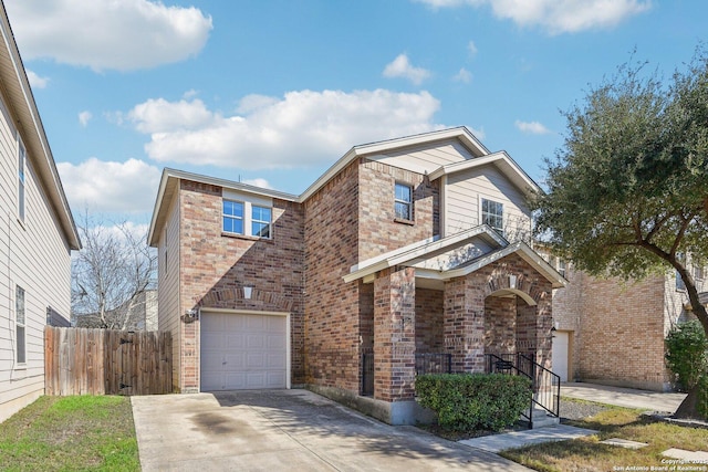 traditional-style home featuring fence, concrete driveway, and brick siding