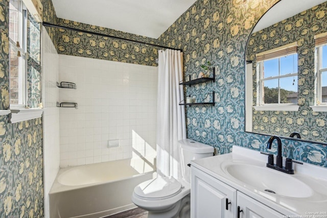 full bath featuring shower / bath combo, vanity, toilet, and wallpapered walls