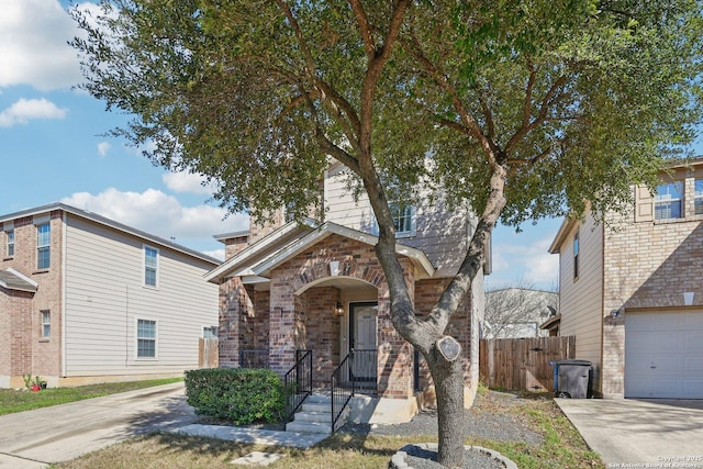 view of front of home with concrete driveway, brick siding, and fence