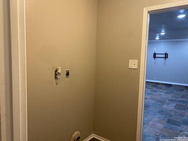 clothes washing area with laundry area, baseboards, and electric dryer hookup