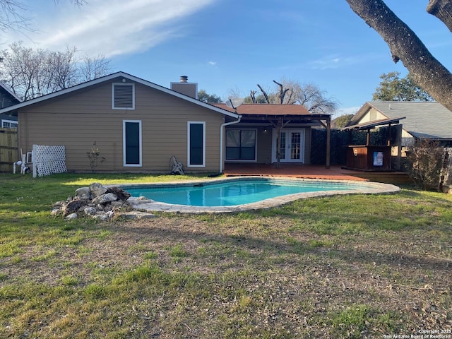 pool with a yard and french doors