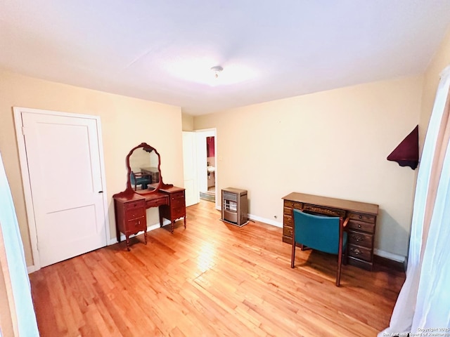 office space with baseboards and light wood-style floors