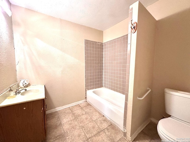 bathroom with toilet, baseboards, a textured ceiling, and vanity