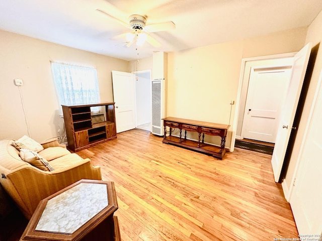 sitting room with ceiling fan and light wood-style flooring