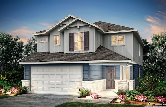 craftsman house with a garage, stone siding, board and batten siding, and driveway