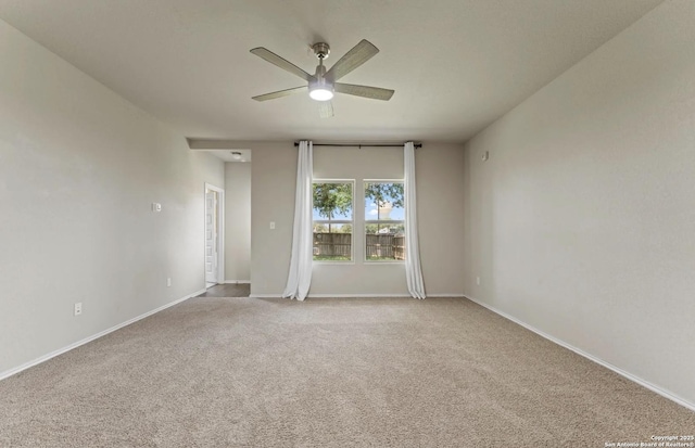 unfurnished room featuring light carpet, ceiling fan, and baseboards