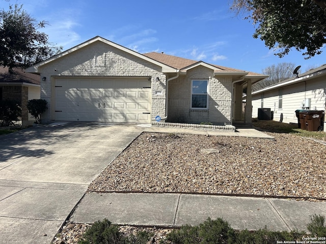 single story home with central air condition unit, a garage, brick siding, concrete driveway, and roof with shingles