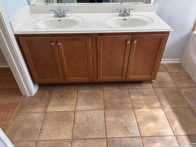 bathroom with a sink and double vanity