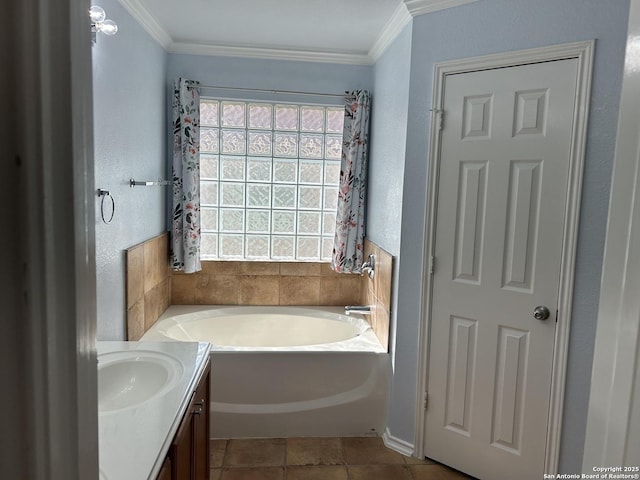 full bathroom featuring a garden tub, a textured wall, crown molding, and vanity