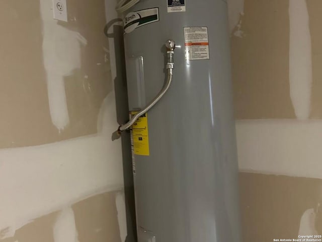 utility room featuring water heater