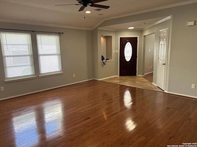 entrance foyer with ornamental molding, wood-type flooring, baseboards, and a ceiling fan