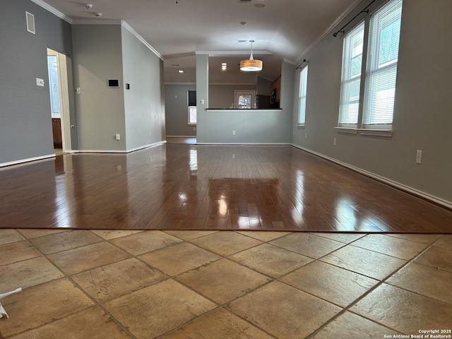 interior space with baseboards, visible vents, ornamental molding, and wood finished floors