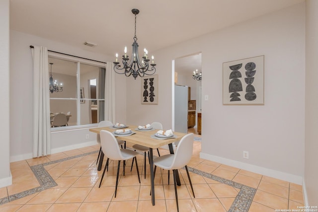 dining room with light tile patterned floors, a chandelier, visible vents, and baseboards